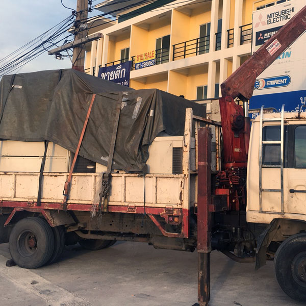 Image of the transport of a large second-hand factory air conditioner.